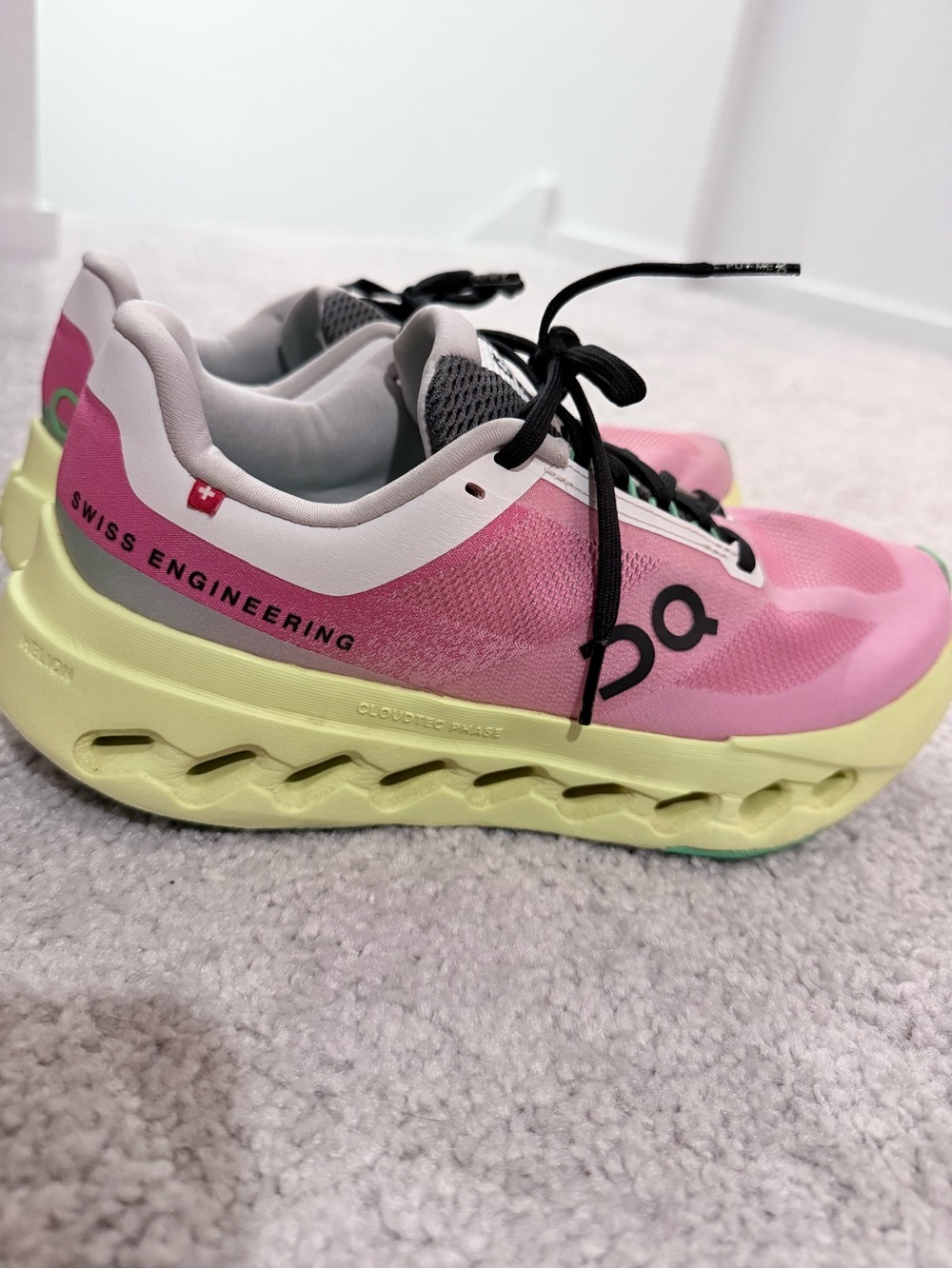 On Running Sneakers with Pink Accents and Green Insole